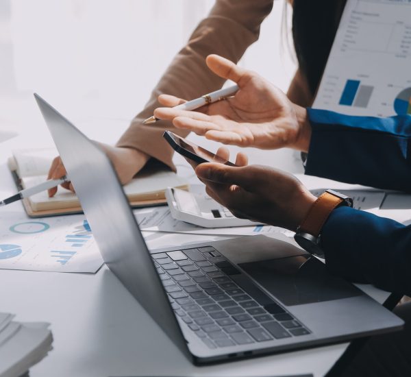 Business team working with new startup project plan and discussion information for financial strategy with laptop and digital tablet in a modern business lounge.